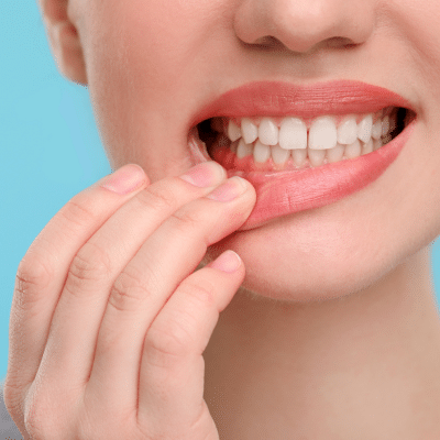 Person showing gum health concern, representing gingivitis vs periodontitis